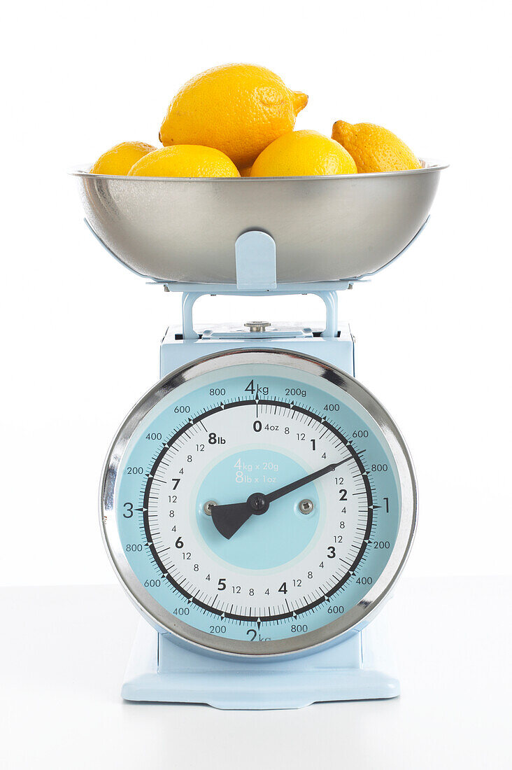 Bowl of lemons on kitchen scales