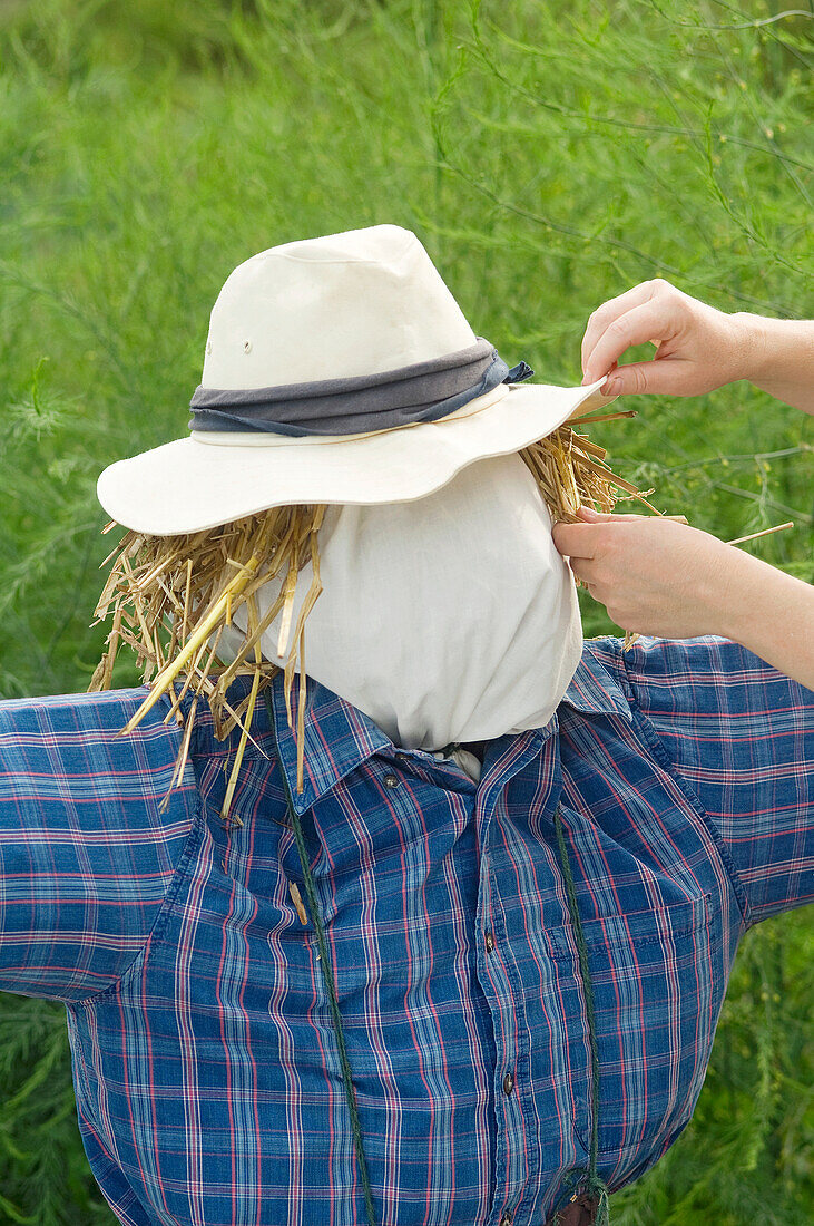 Person making scarecrow
