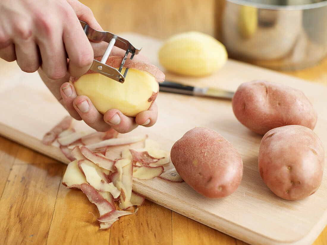 Peeling potatoes with potato peeler
