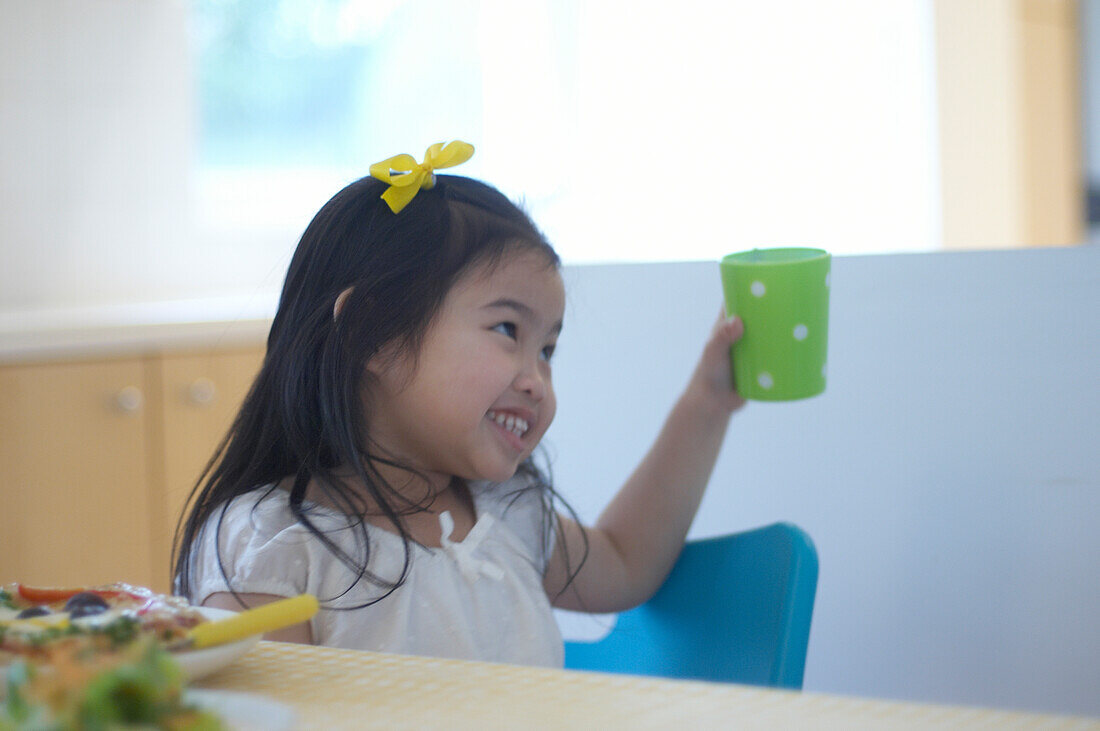 Girl holding green cup