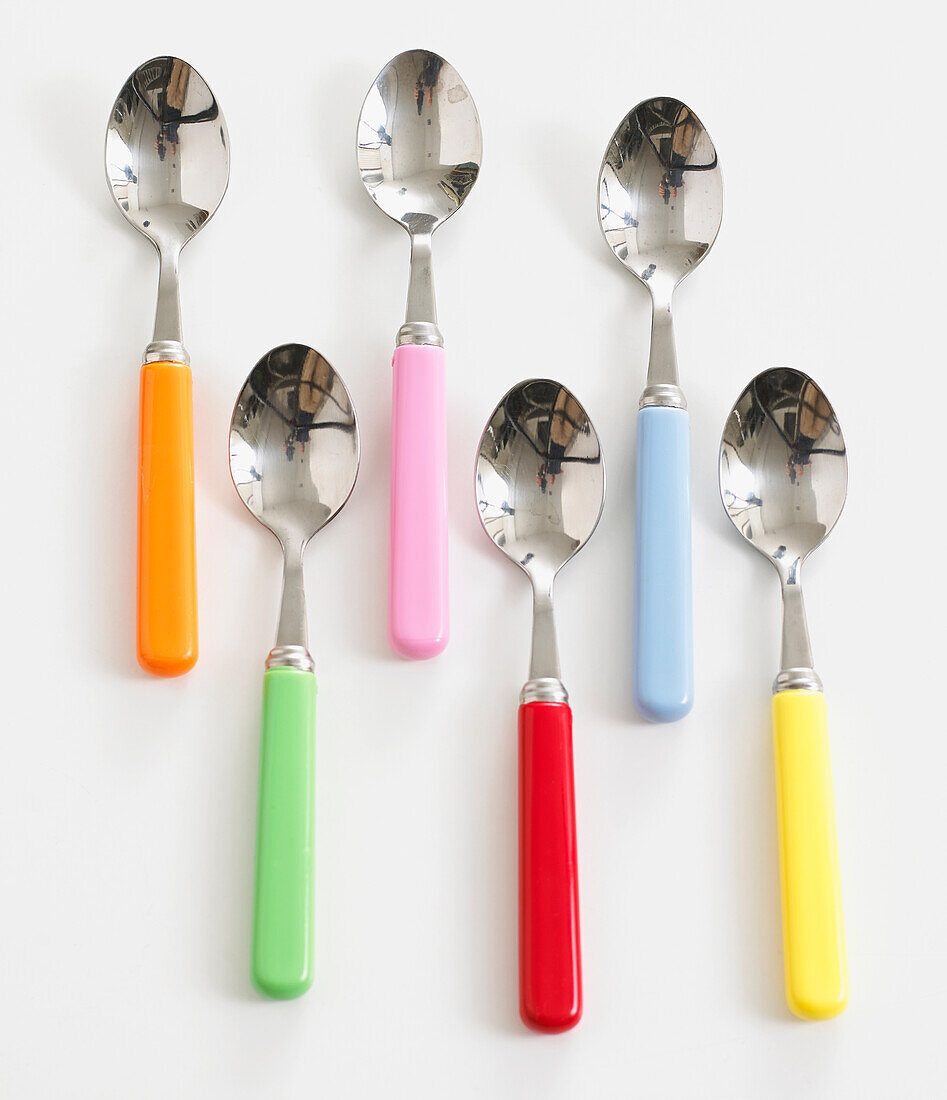 Six colourful teaspoons