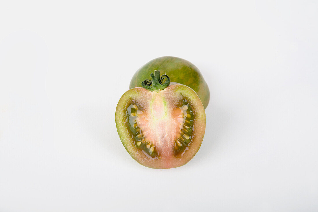 Green tomato cut in half