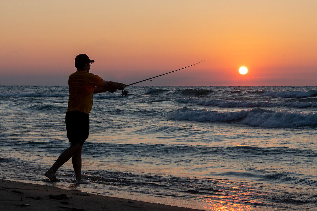Man fishing on Lake Michigan, USA