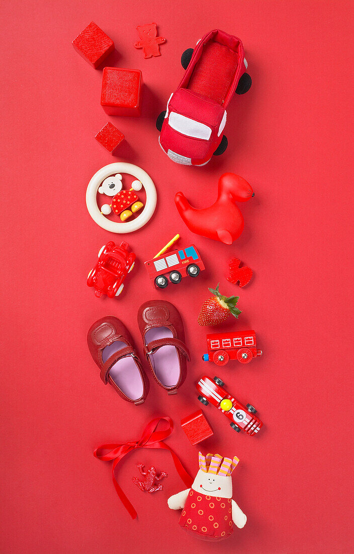 Selection of red toys on red background