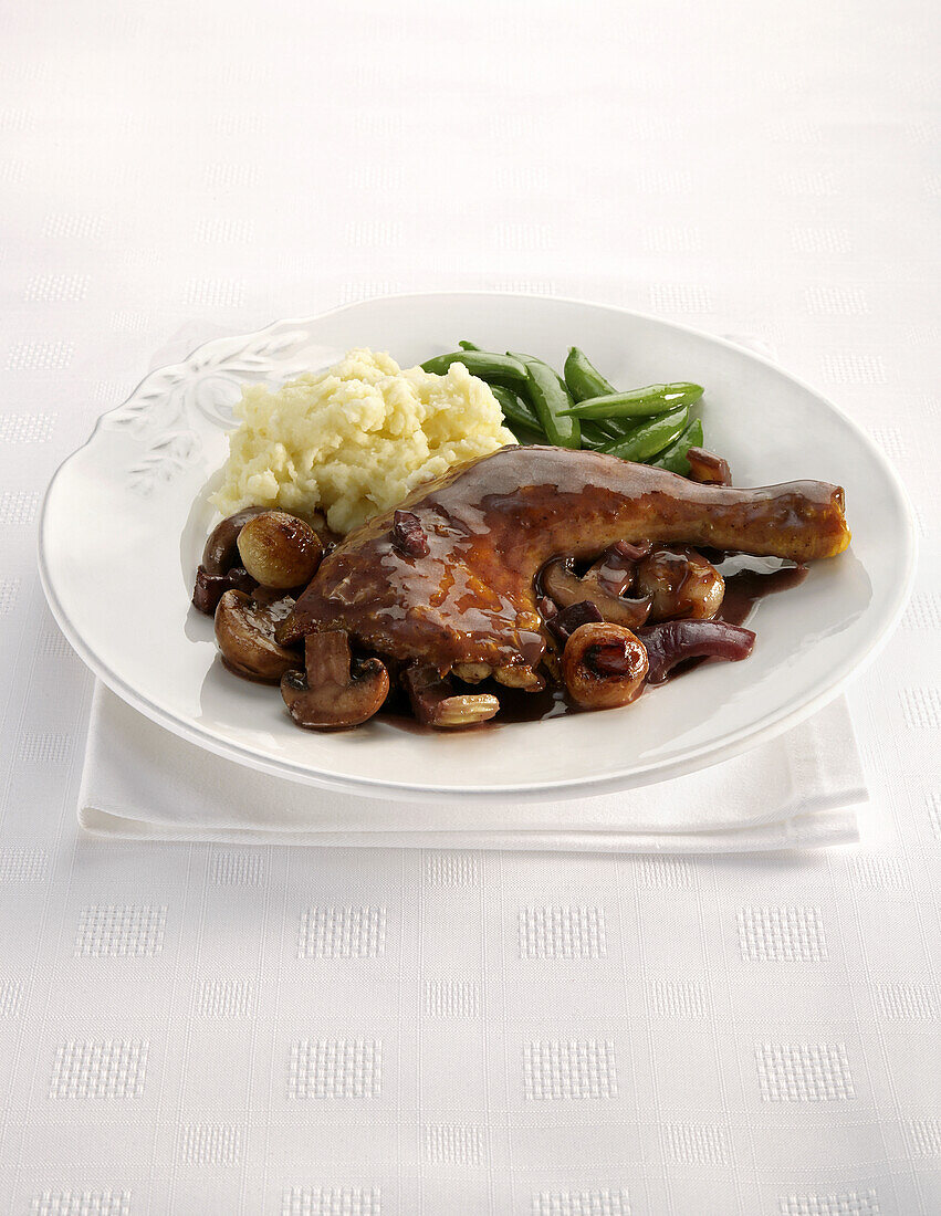 Coq Au Vin on plate with vegetables