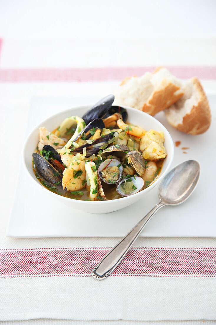 Bowl of Spanish seafood stew and crusty bread