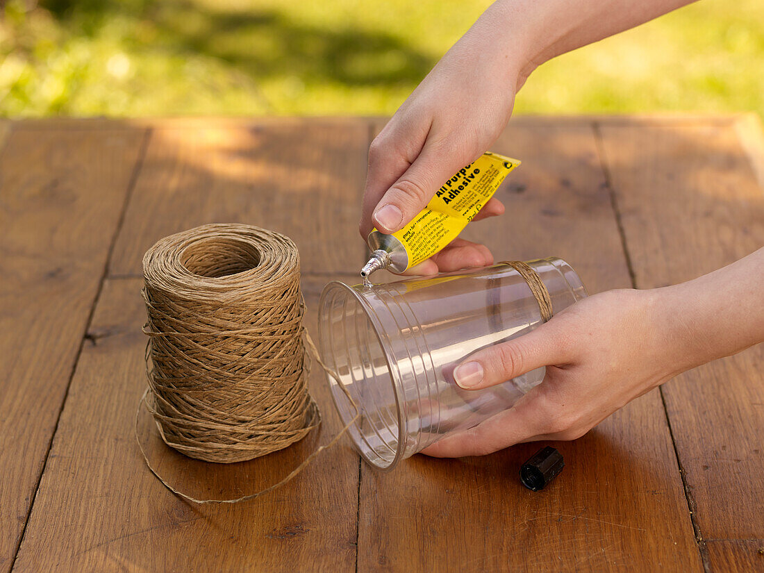 Winding twine around a pot and gluing in place