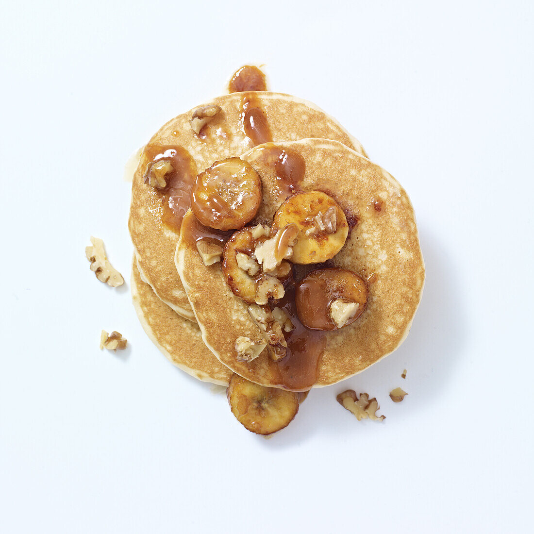 Pancakes topped with caramel, banana and walnuts