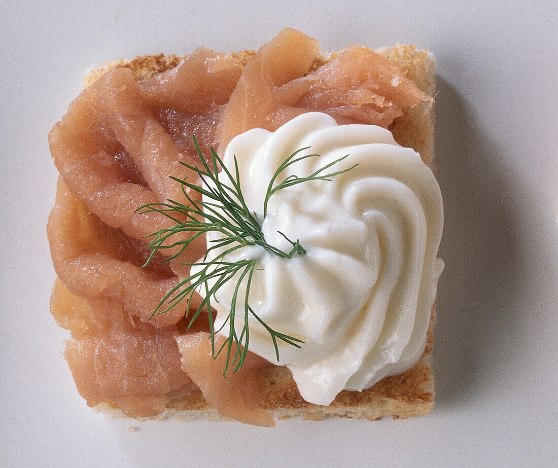 Square of toast with smoked salmon and dill mayonnaise