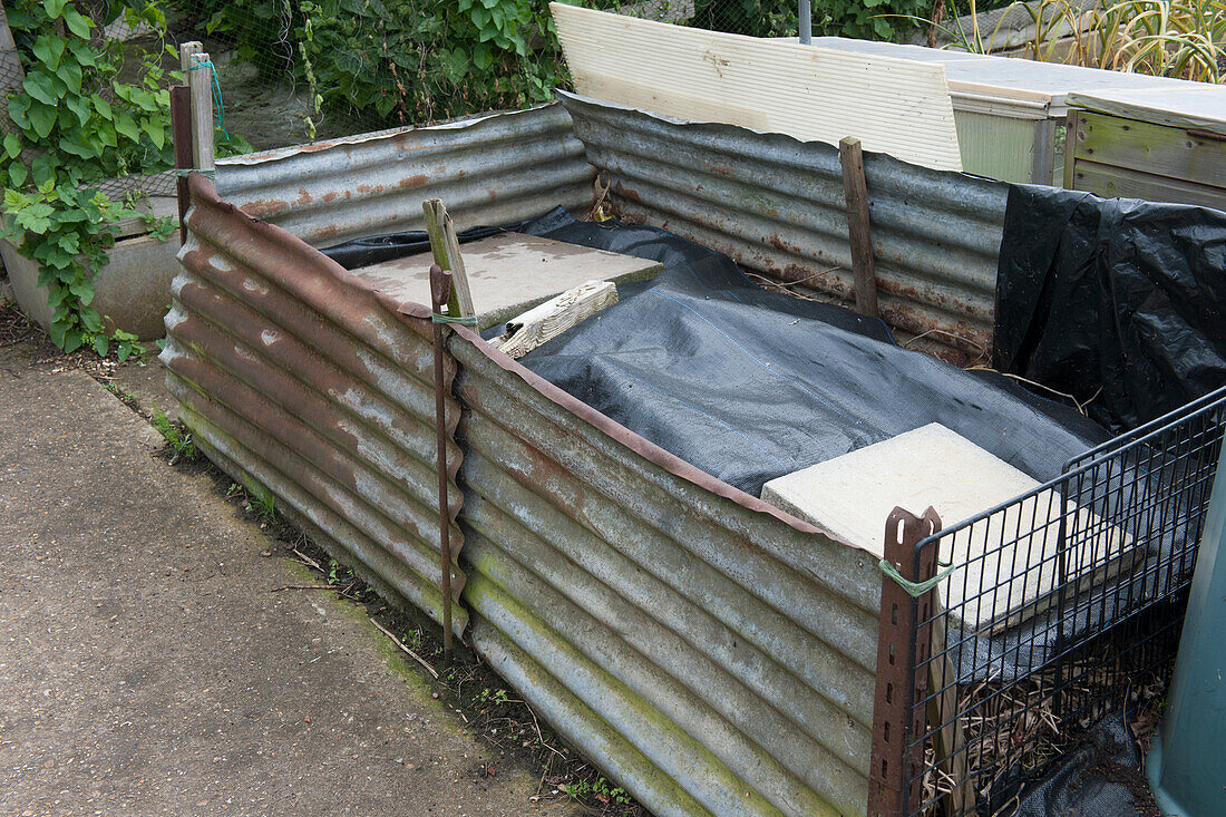 Compost heap constructed from sheets of corrugated iron