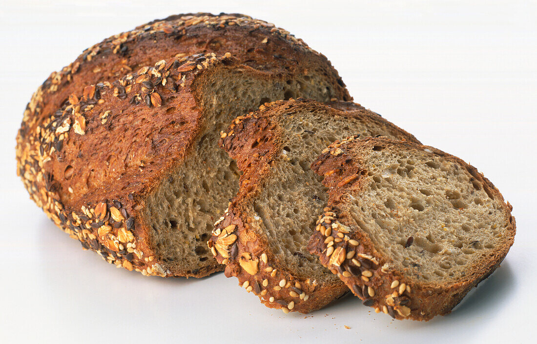 Loaf and slices of wholegrain seeded bread