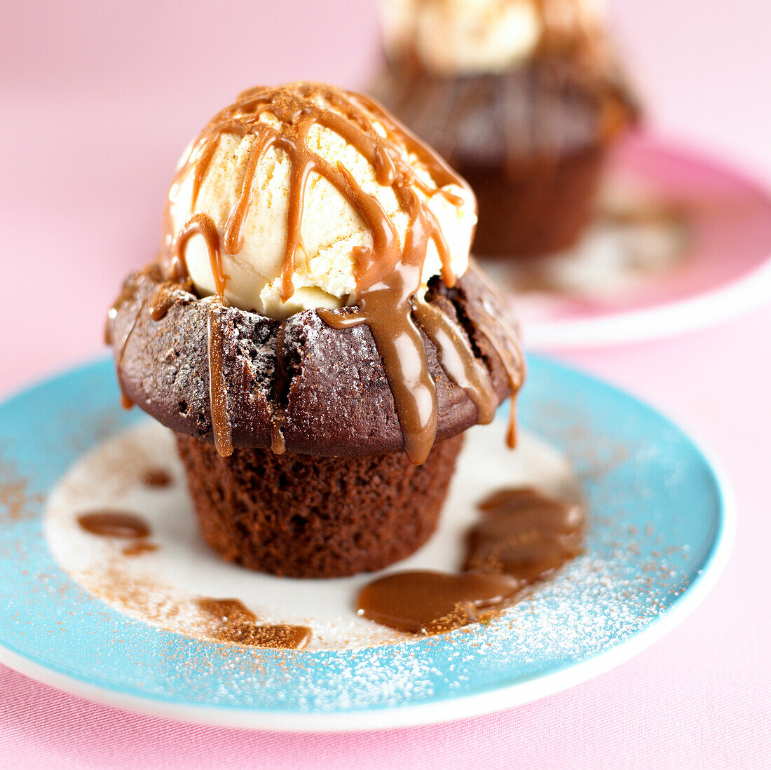 Chocolate muffin on plate with ice cream and sauce on top