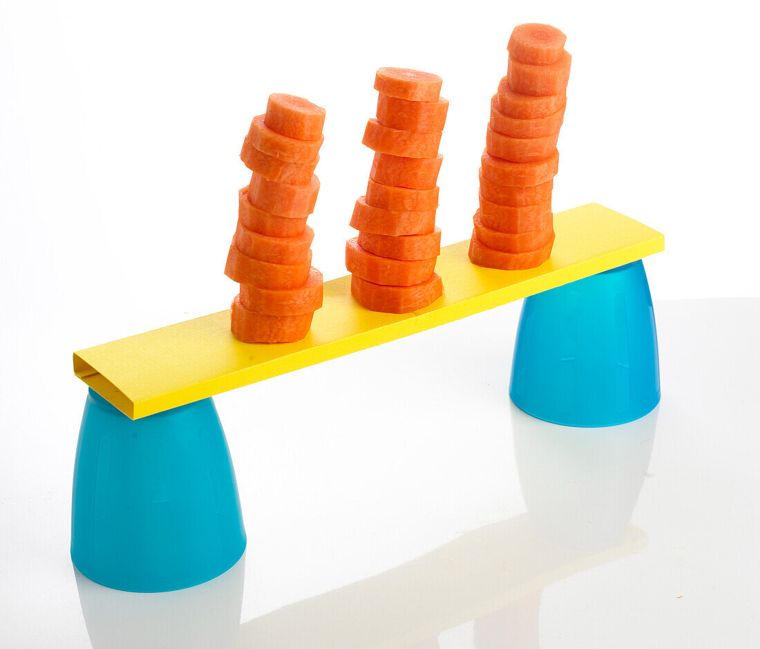 Stacks of chopped carrots balanced on plastic cups