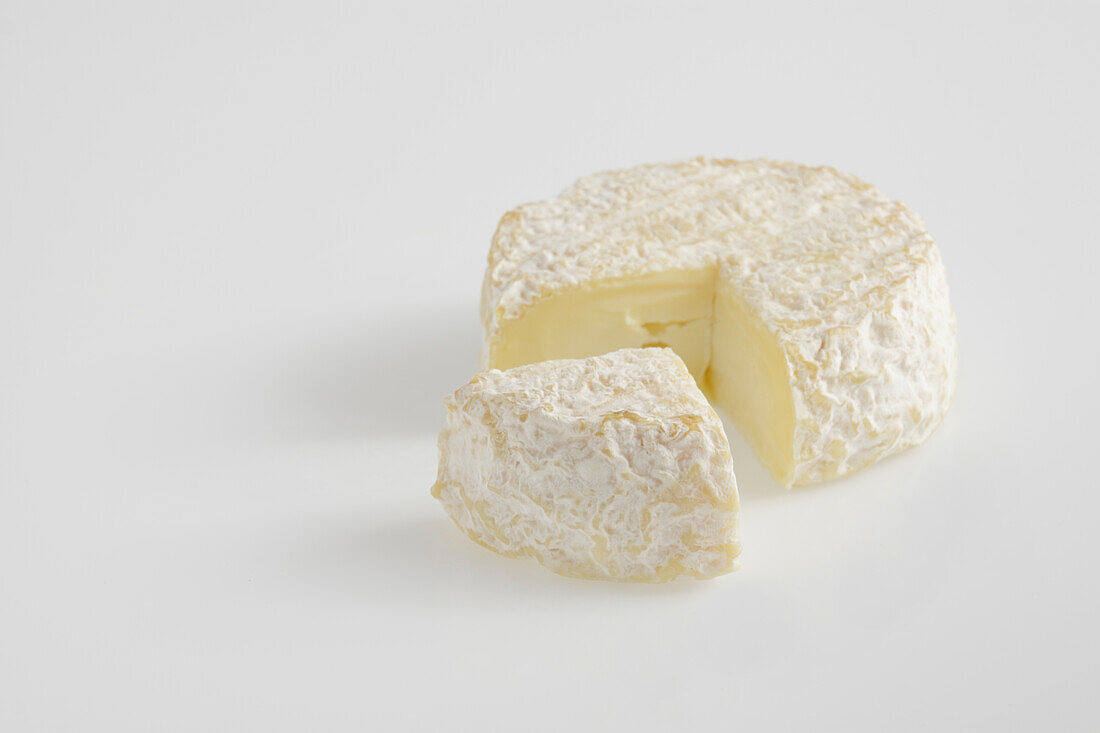 Sliced whole round of French Saint-Marcellin cow's milk cheese