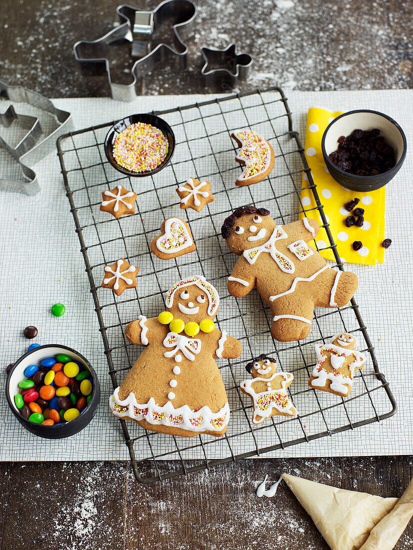 Gingerbread men and shapes with icing on cooling rack