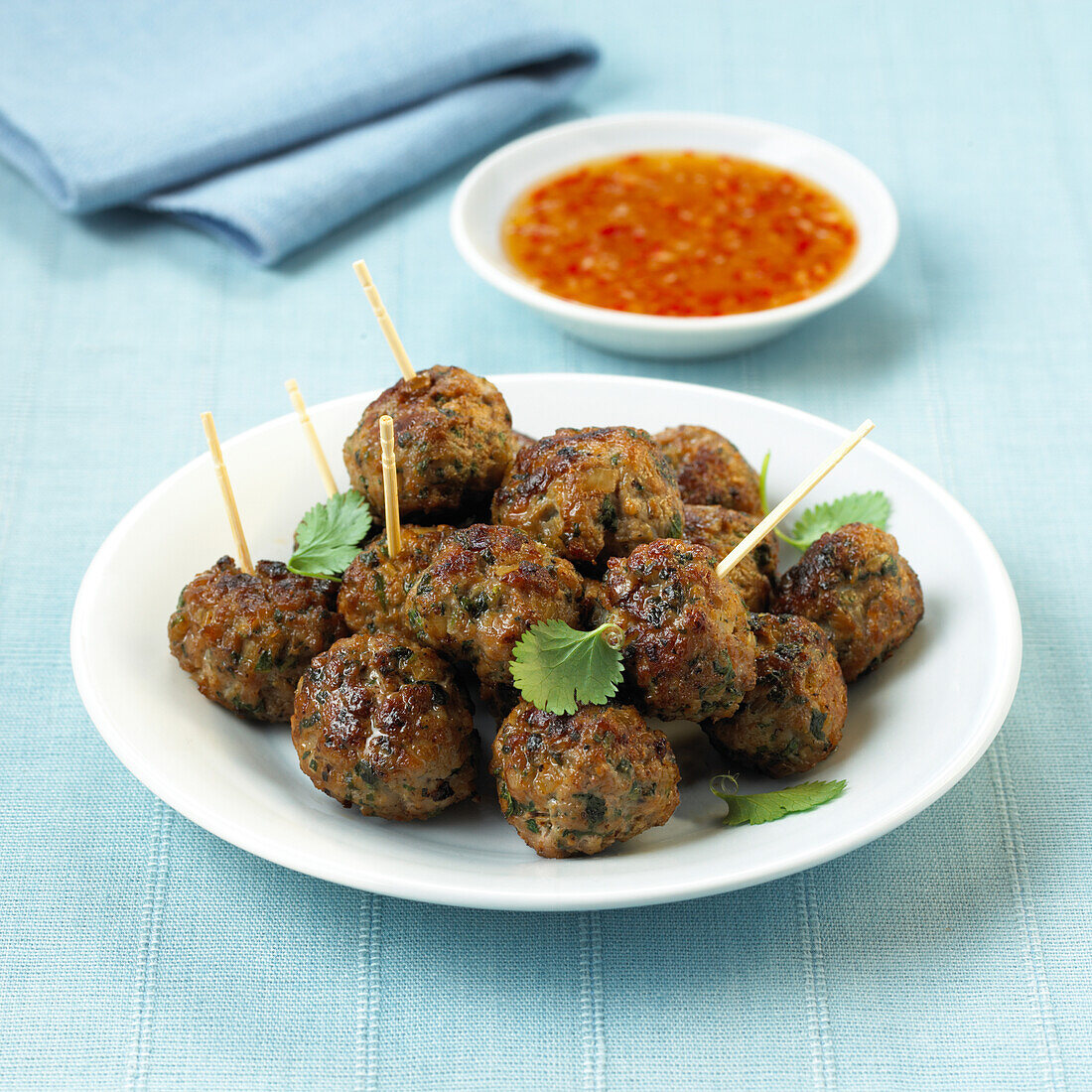 Plate of pork meatballs served with sweet chilli sauce