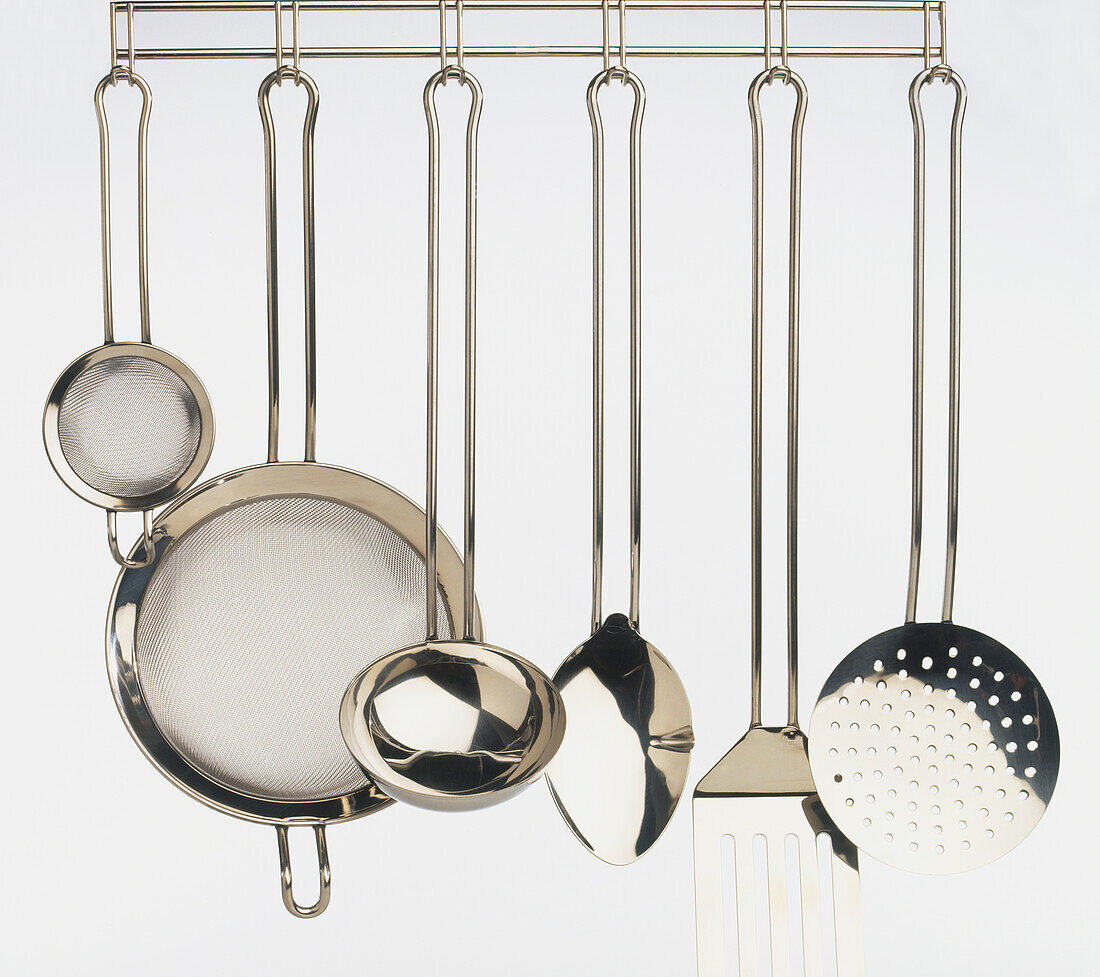 Cooking utensils hanging from a rack