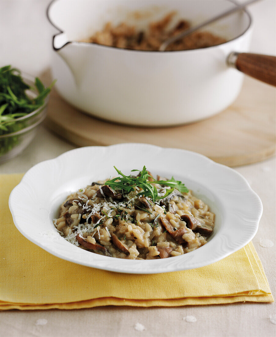 Mushroom risotto with rocket leaves and parmesan cheese