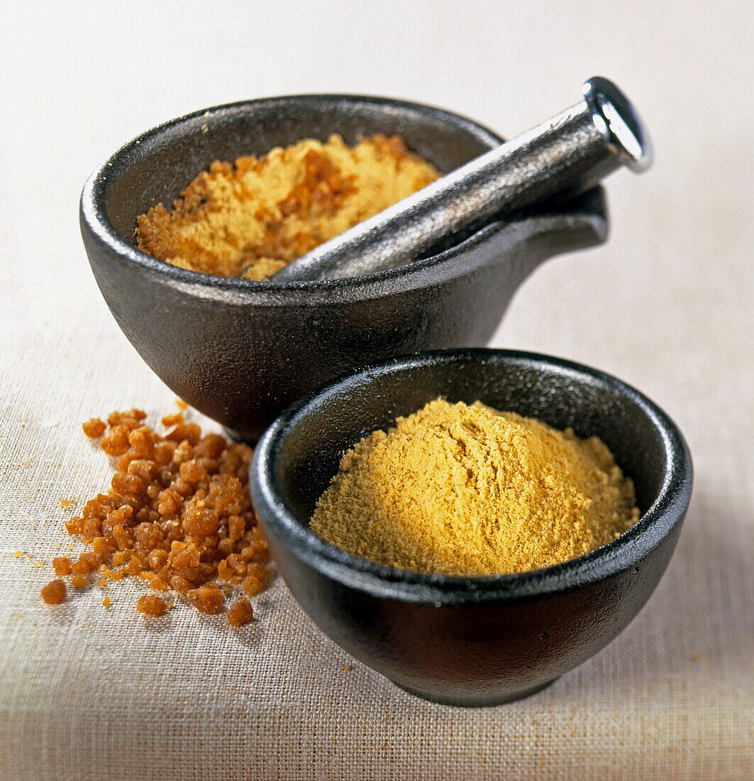 Asafoetida in mortar with pestle and black bowl