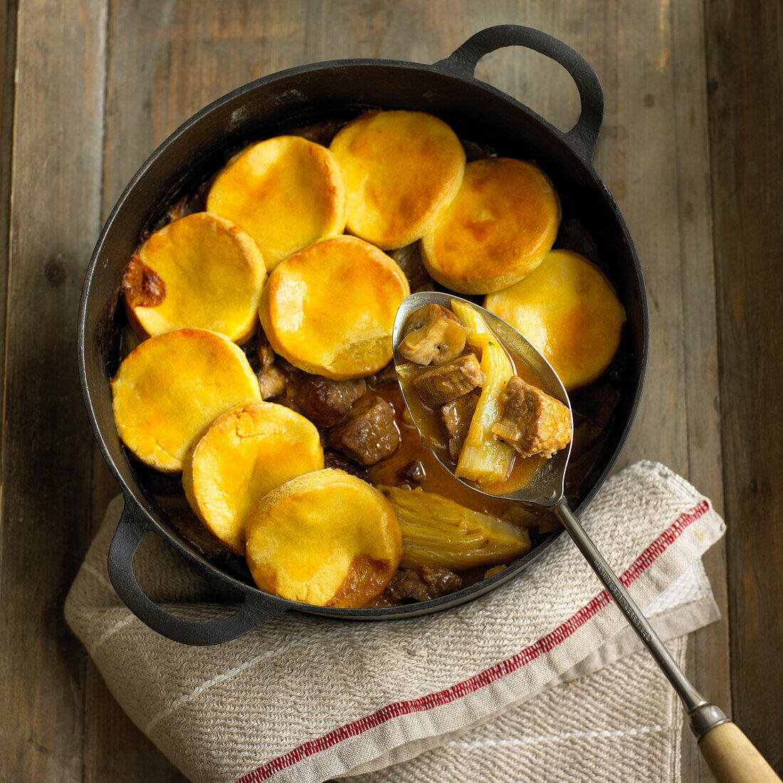 Beef, fennel and mushroom cobbler in cast-iron pan