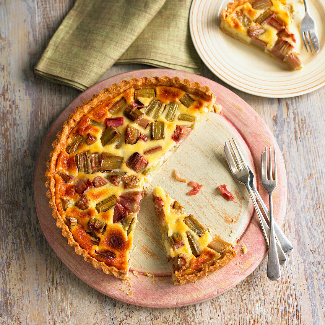 Rhubarb and custard tart with a slice cut away