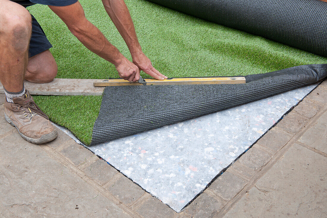 Laying artificial turf