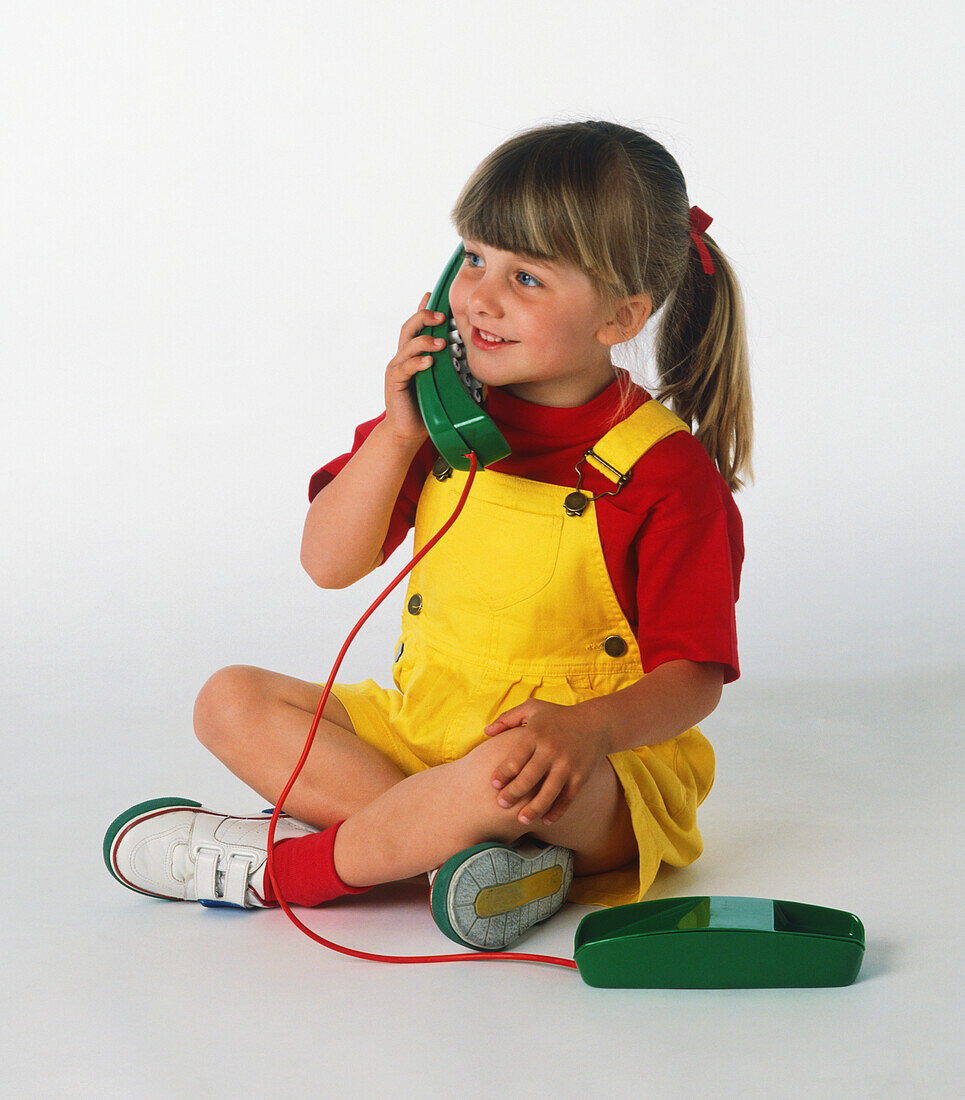 Young girl talking on a telephone