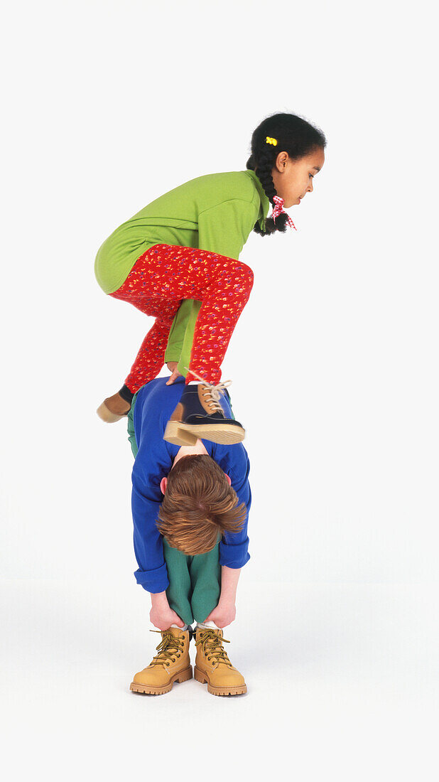 Girl and boy playing leapfrog