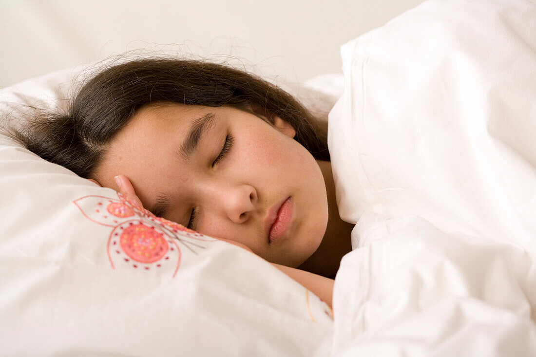 Girl asleep with her head on pillow