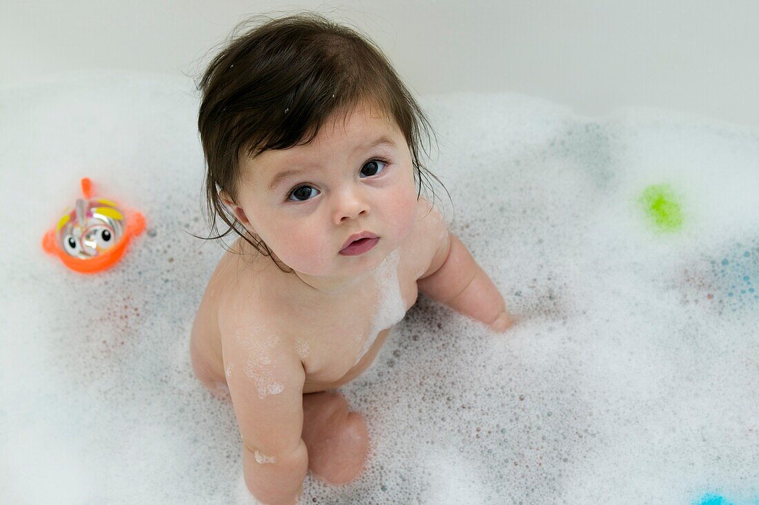 Baby girl sitting in bath