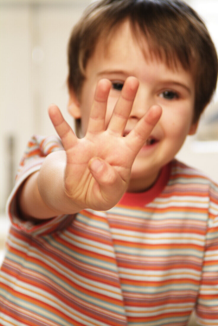 Boy holding four fingers up