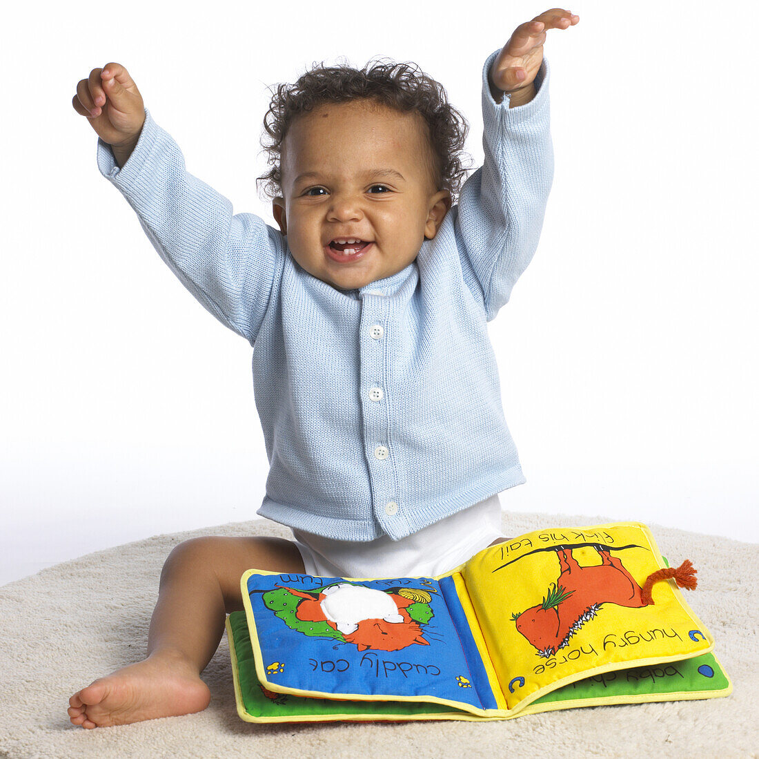 Baby girl sitting with picture book