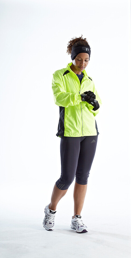 Woman wearing running clothes checking her watch
