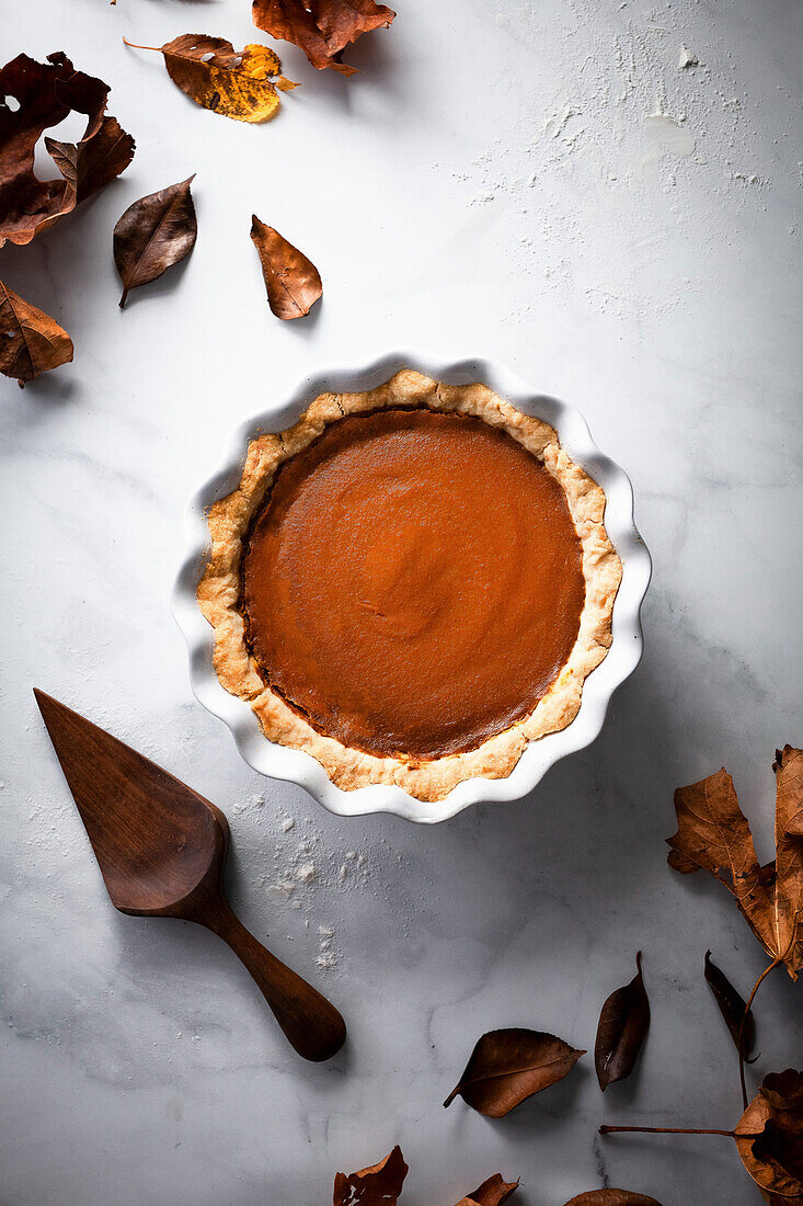 A pumpkin pie and fall leaves