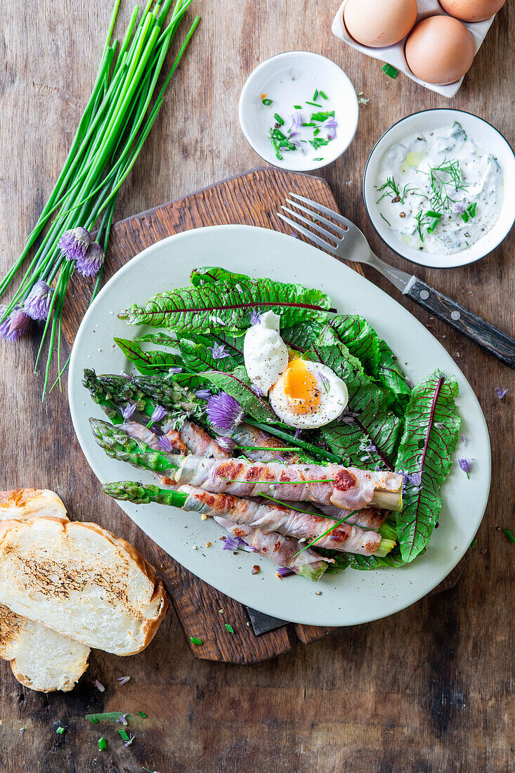 Asparagus fried in bacon with soft bolied egg