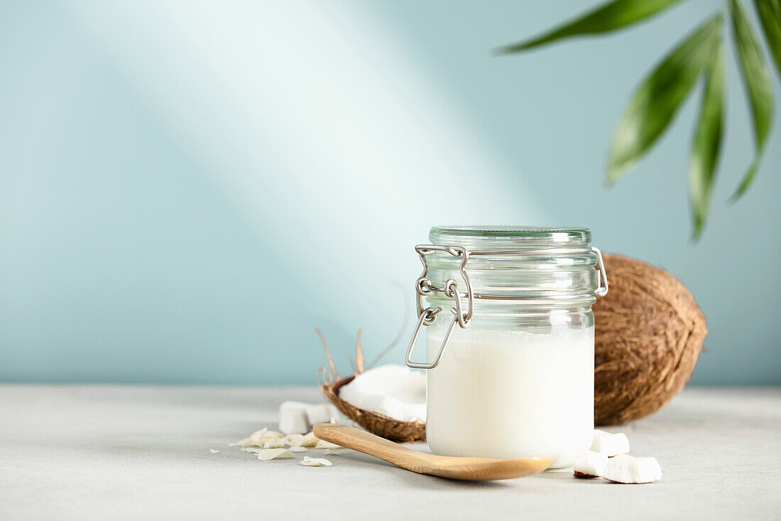Coconut oil in jar with fresh coconut
