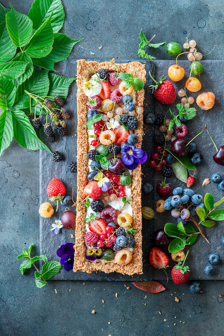 Dissicated coconut, wholewheat flour, coconut oil base pie with cream and berries