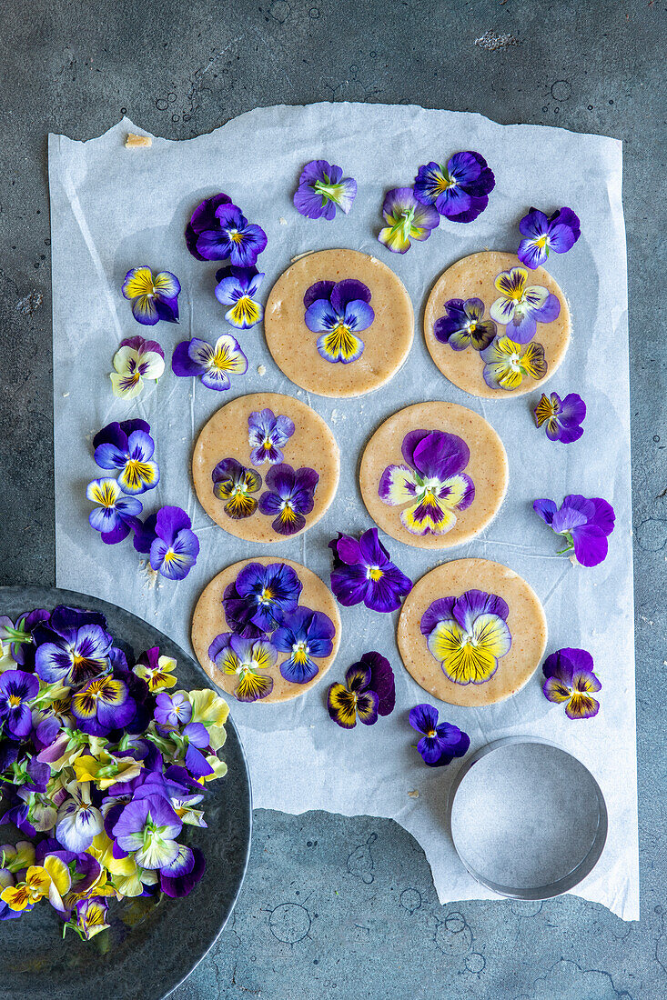 Making floral biscuits with pansies