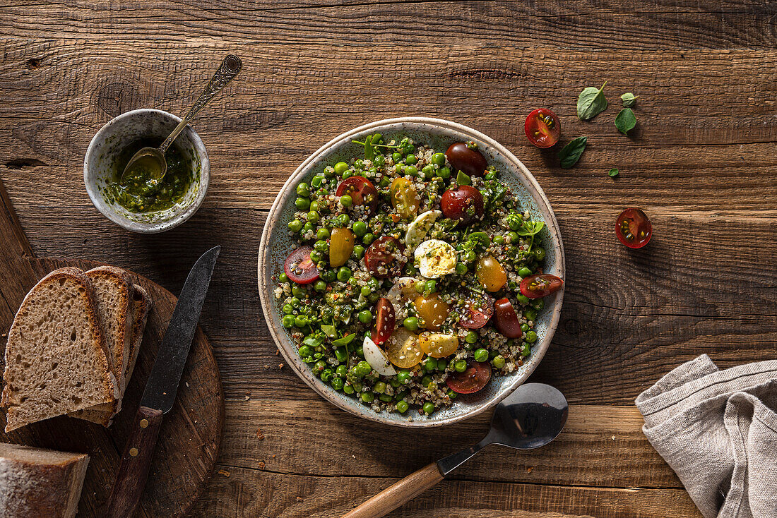 Quinoa salad with green peas, tomatoes and eggs
