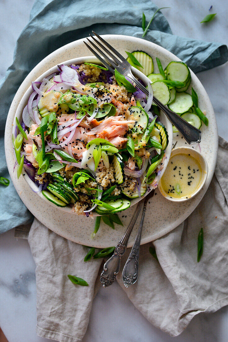 A healthy salad with salmon quinoa and zucchini