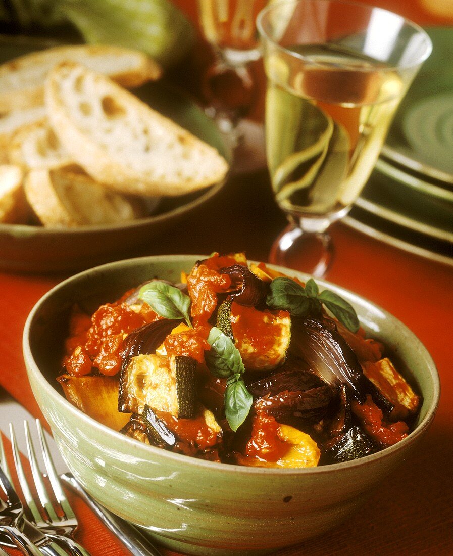 A Bowl of Ratatouille with Bread and Wine