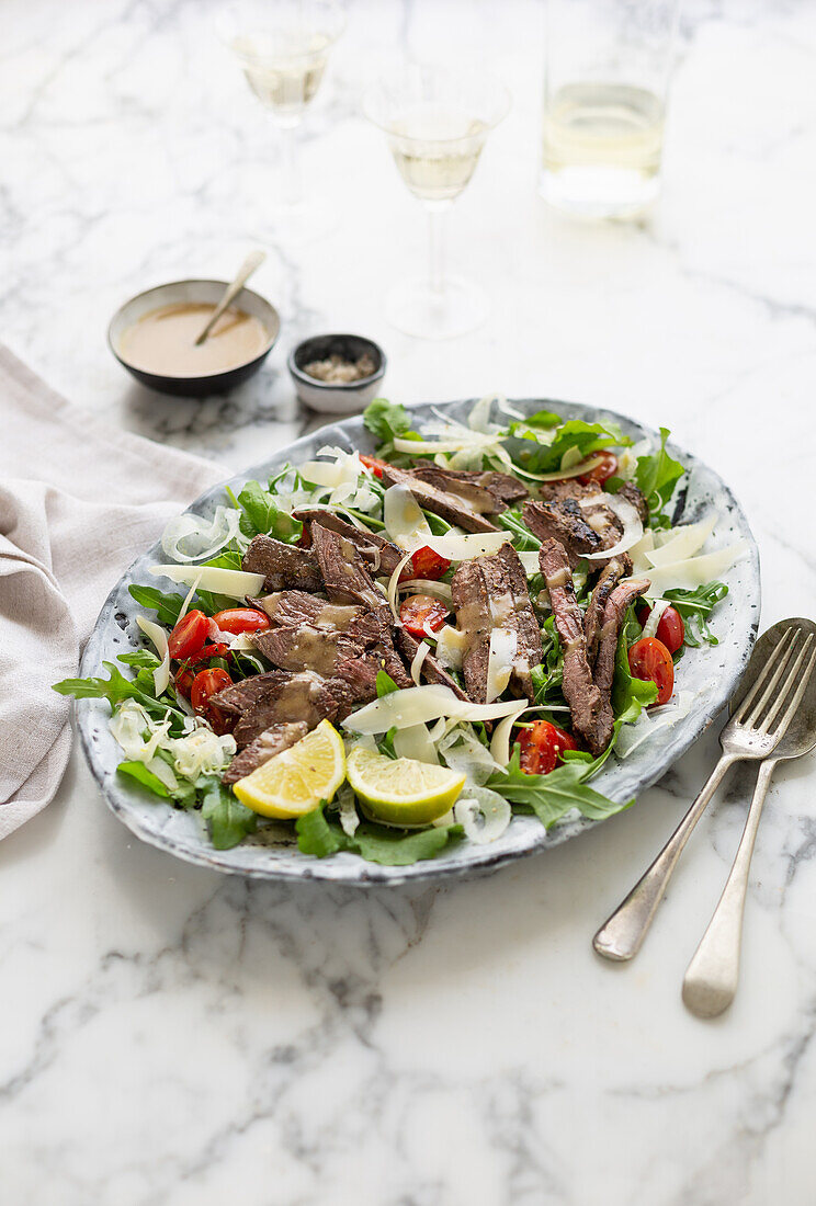 Beef tagliata on rocket salad