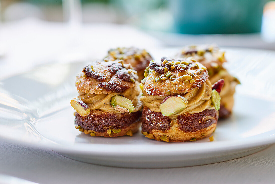 Choux pastries with a cream filling and pistachios