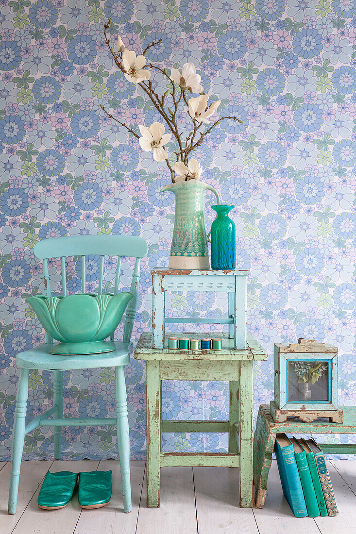 Still life of blue and green chair, stools and books