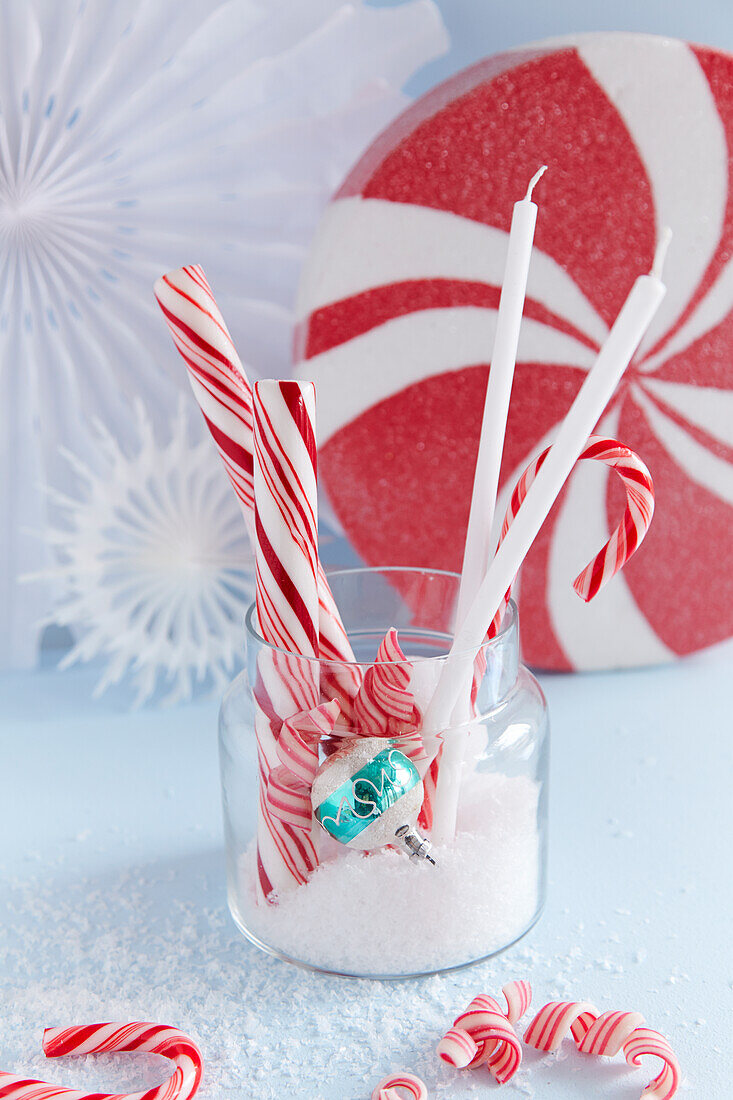 DIY Christmas decoration with artificial snow, candy canes, and candles