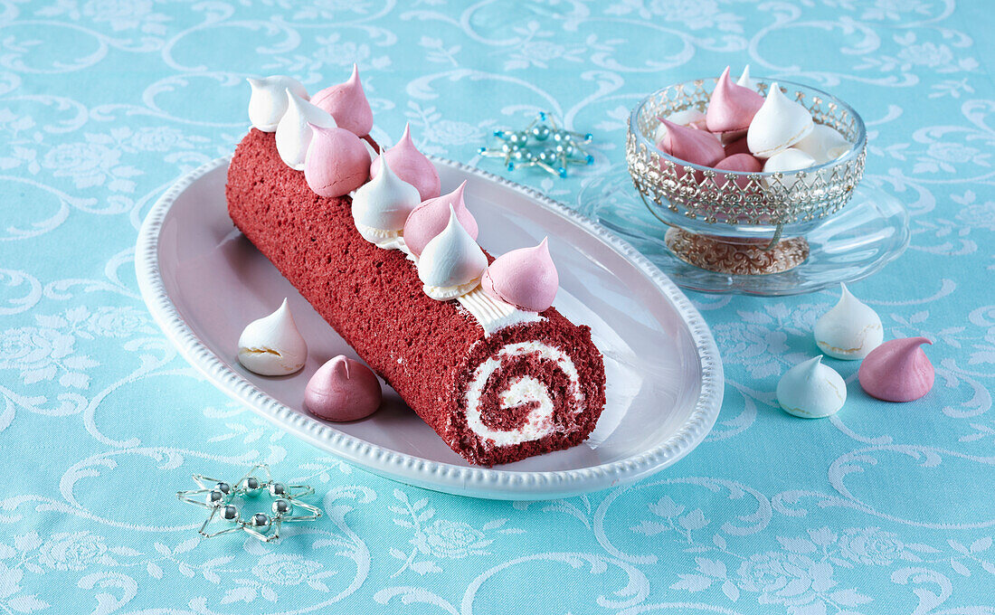 Red velvet Swiss roll decorated with meringue dots