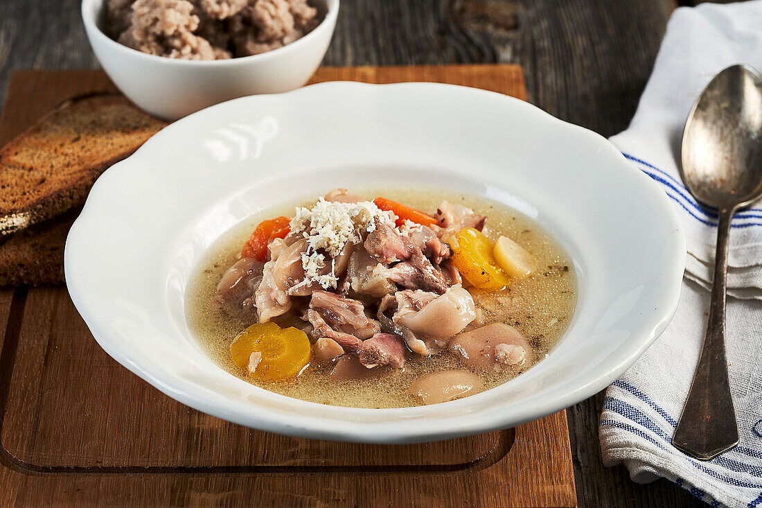 Styrian Klachlsuppe (soup with pork, root vegetables and spices) topped with buckwheat crumbles