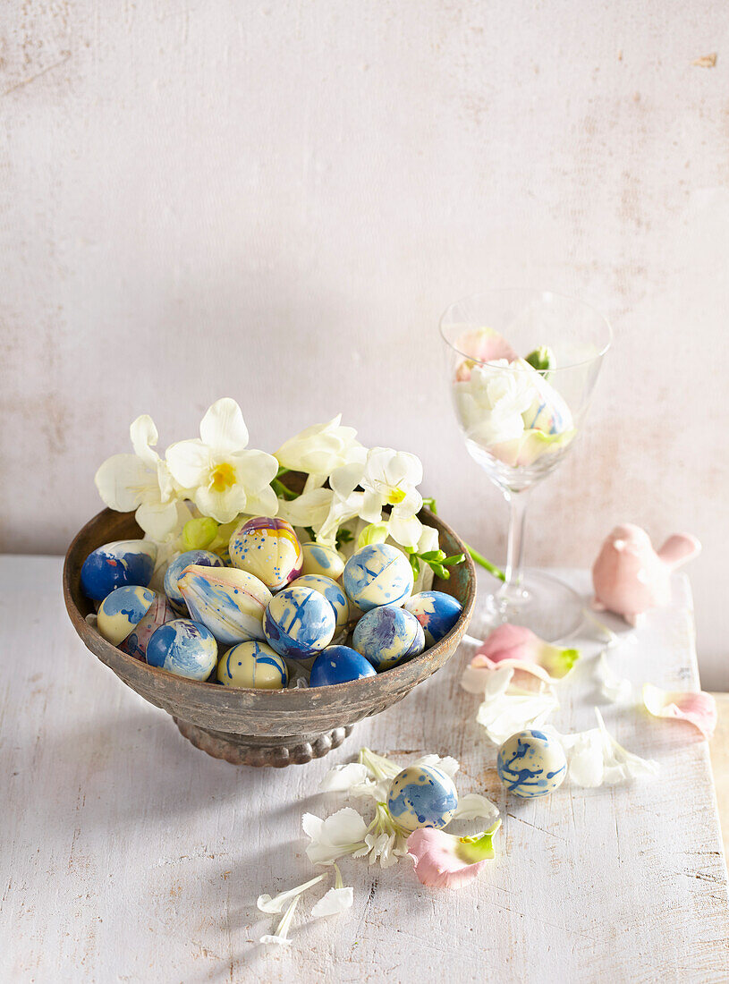 Blue and white marbled chocolate eggs with liqueur