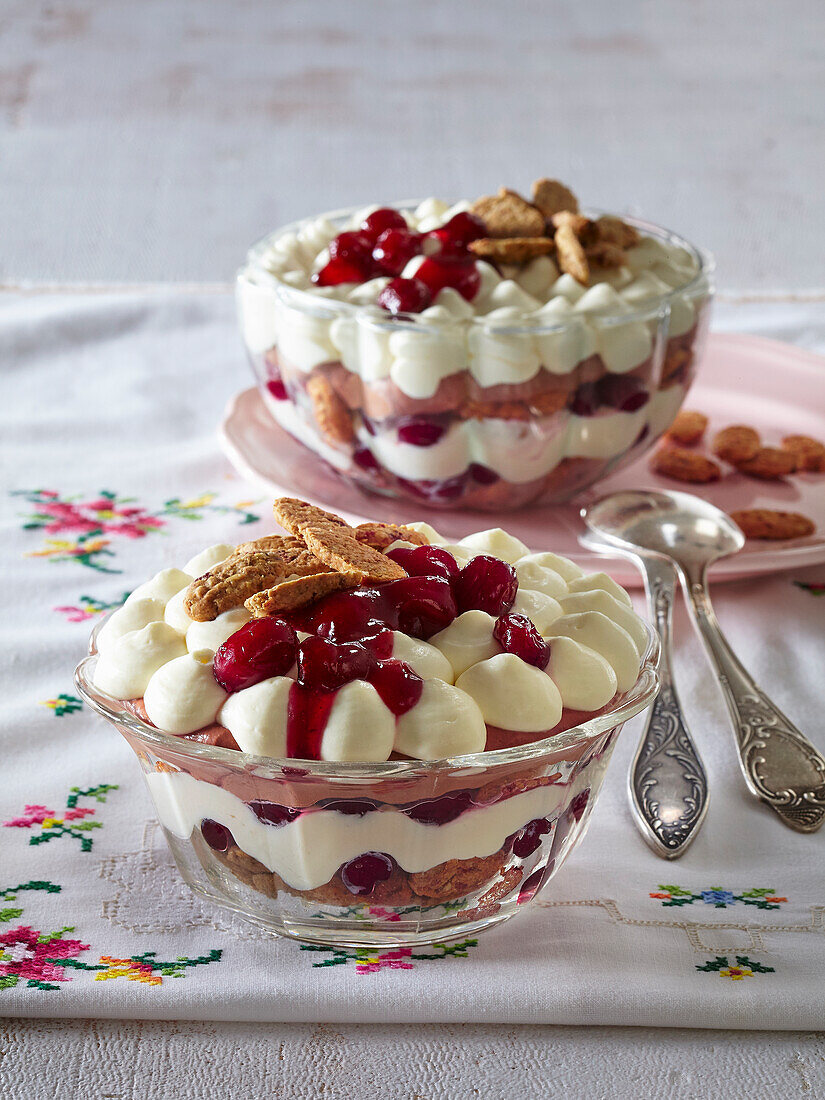Layered dessert with chocolate cream, cream, and cranberries