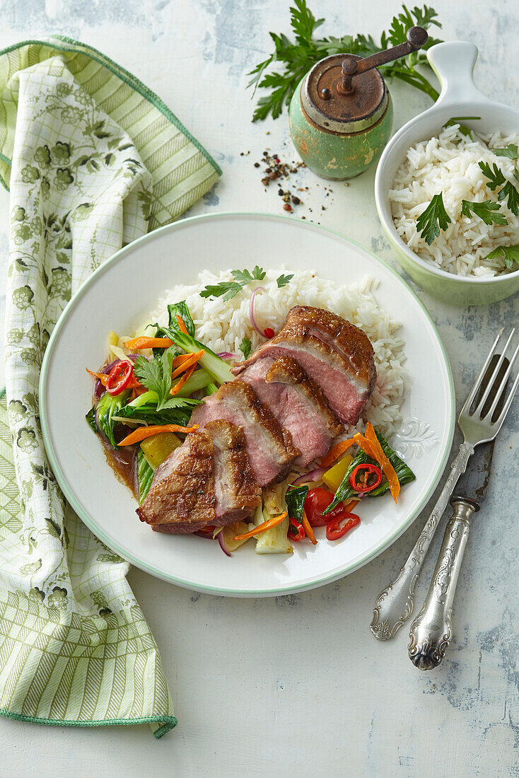 Asian style duck breast with vegetables and rice